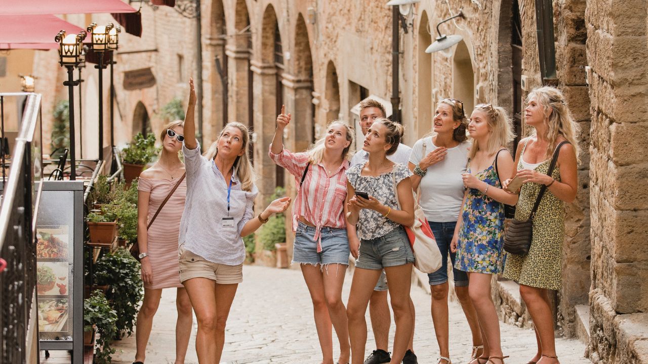 walking tour Group of people in a walking tour in Siena